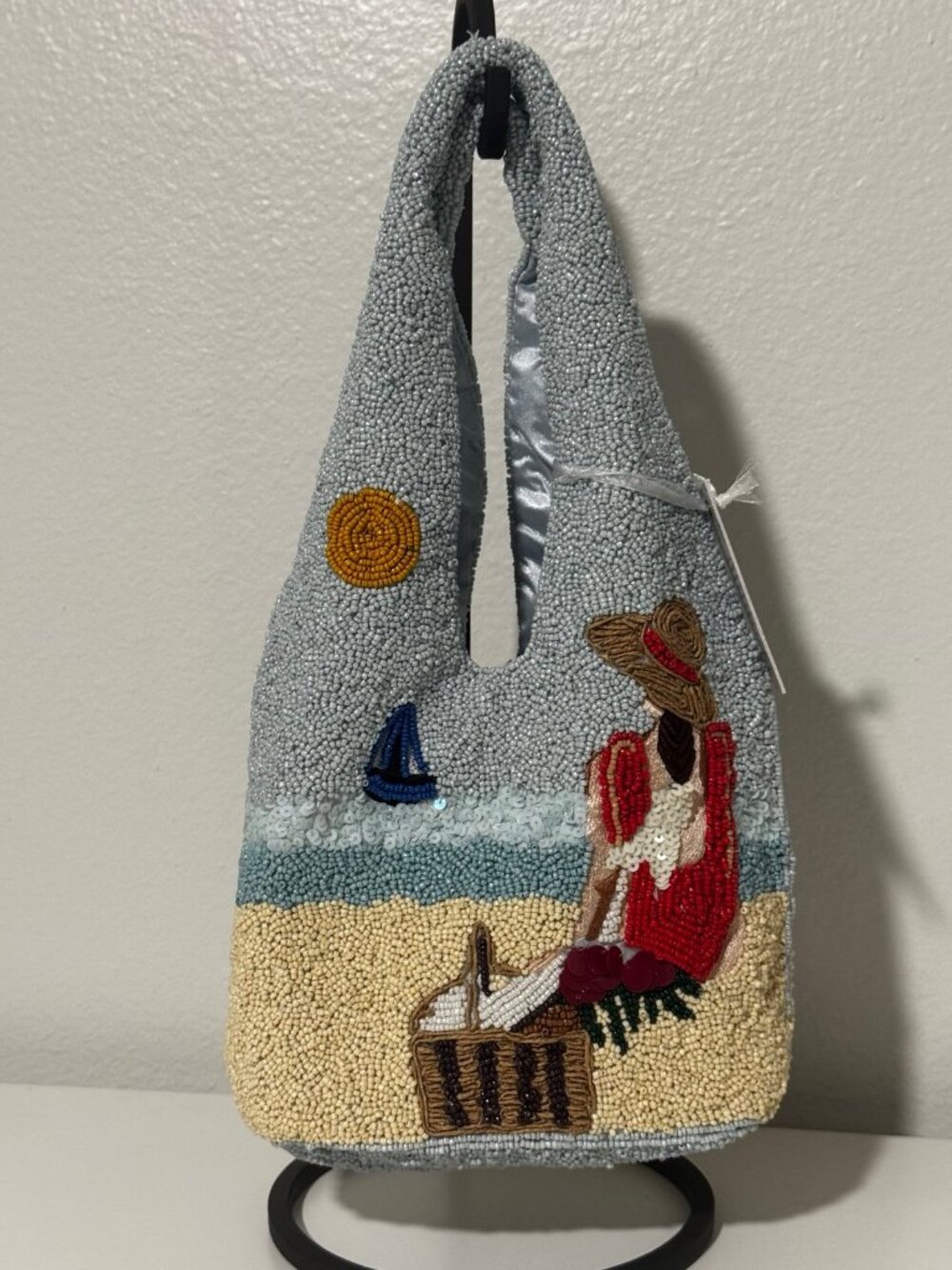 Viral beaded bag handcrafted in India woman at the beach in red